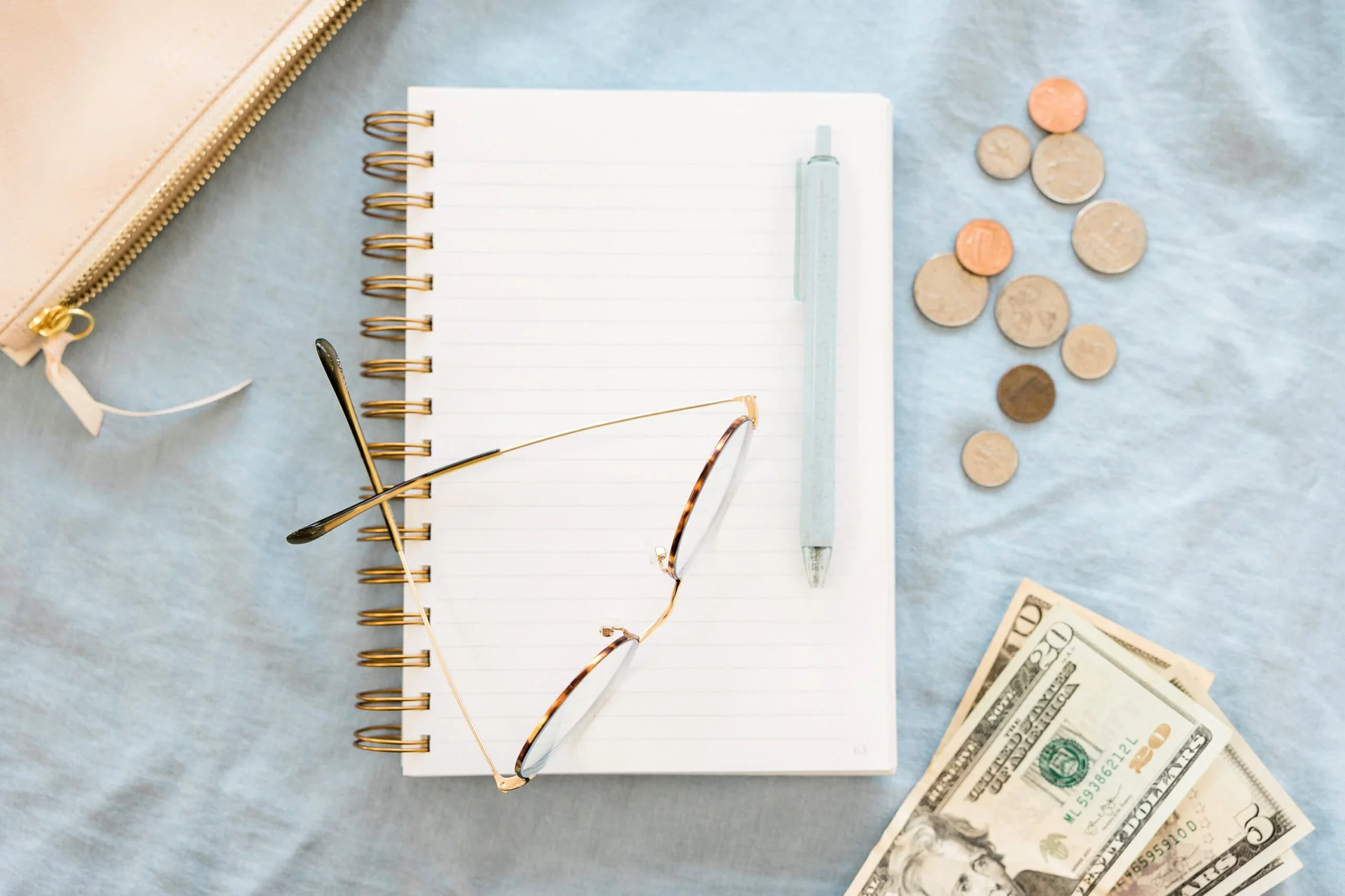 Notebook glasses money blue scaled.jpg