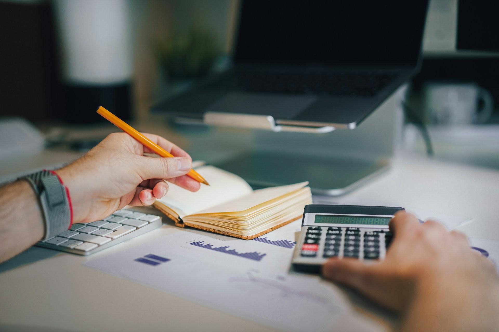 Financial decisions to make before going freelancer calculating finances with a calculator and noteb.jpeg